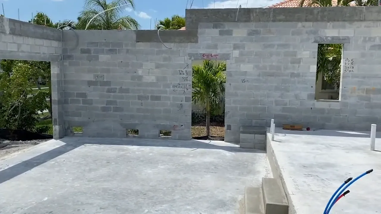 Block walls rising on-site with construction crew working