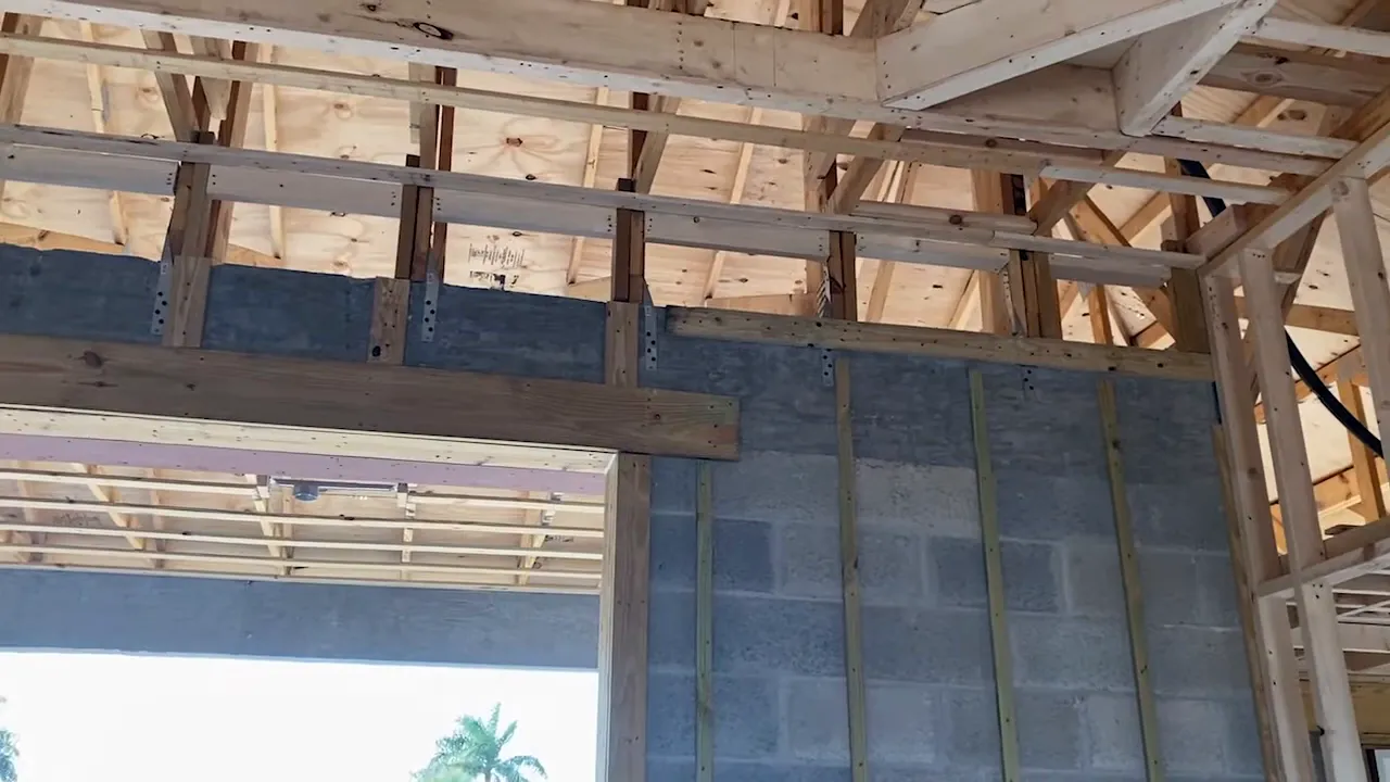 Close up of tie beam showing embedded steel and strap connections