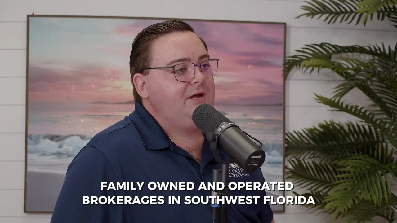Podcast guest speaking into a microphone in a studio with a beach painting and plant behind; on-screen subtitle reads 'FAMILY OWNED AND OPERATED BROKERAGES IN SOUTHWEST FLORIDA'.