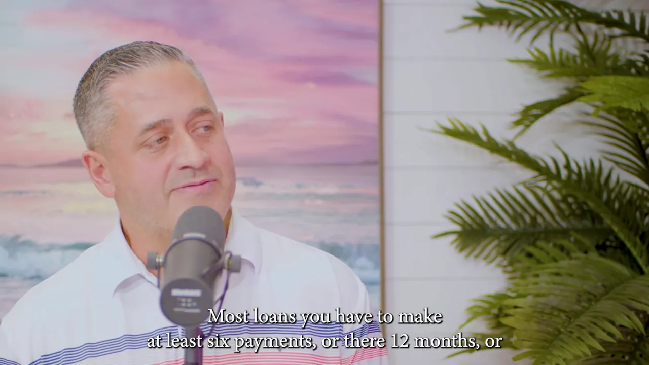 Studio interview frame showing a lender at a microphone with subtitles about loans requiring multiple payments, and a plant backdrop.
