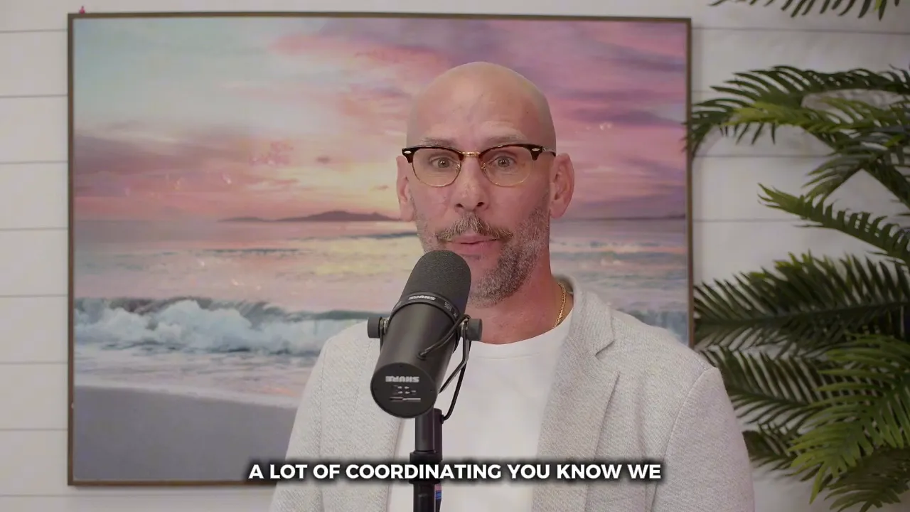Male agent speaking into a microphone with a framed beach painting behind him, mid-sentence about coordinating Open Houses.
