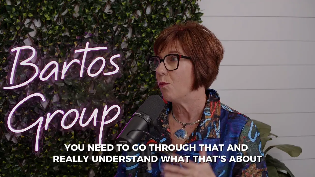 Wider studio shot of a person at a microphone with subtitle 'DO YOU WANT TO BE THE PERSON THAT'S DOING EVERYTHING ALL AT ONCE'.